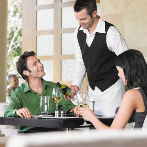 friendly waiter serving guest-Top Veg Punjabi Restaurant In Delhi 2025