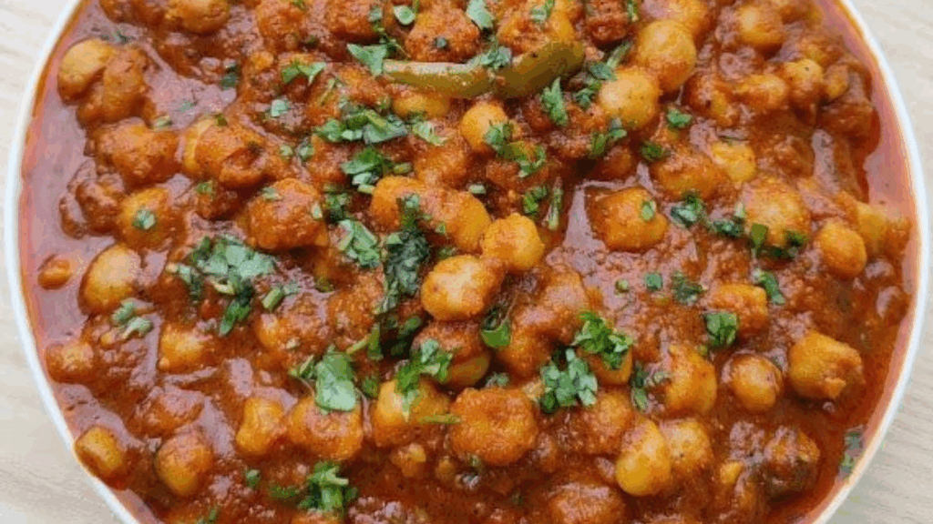Spicy Chole Curry garnished with fresh coriander leaves at zaikastreet