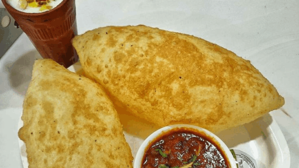 serving Chole Bhature with salad, pickle, and lassi at zaikastreet