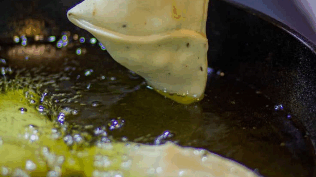 Samosa frying until golden brown at zaikastreet