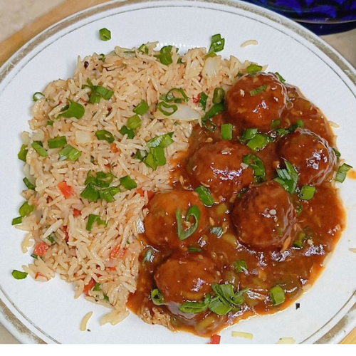 Gobi Manchurian Recipe | crispy & saucy restaurant style gobi manchurian gravy served with vegetable fried rice on a dinner table at zaikastreet restaurant