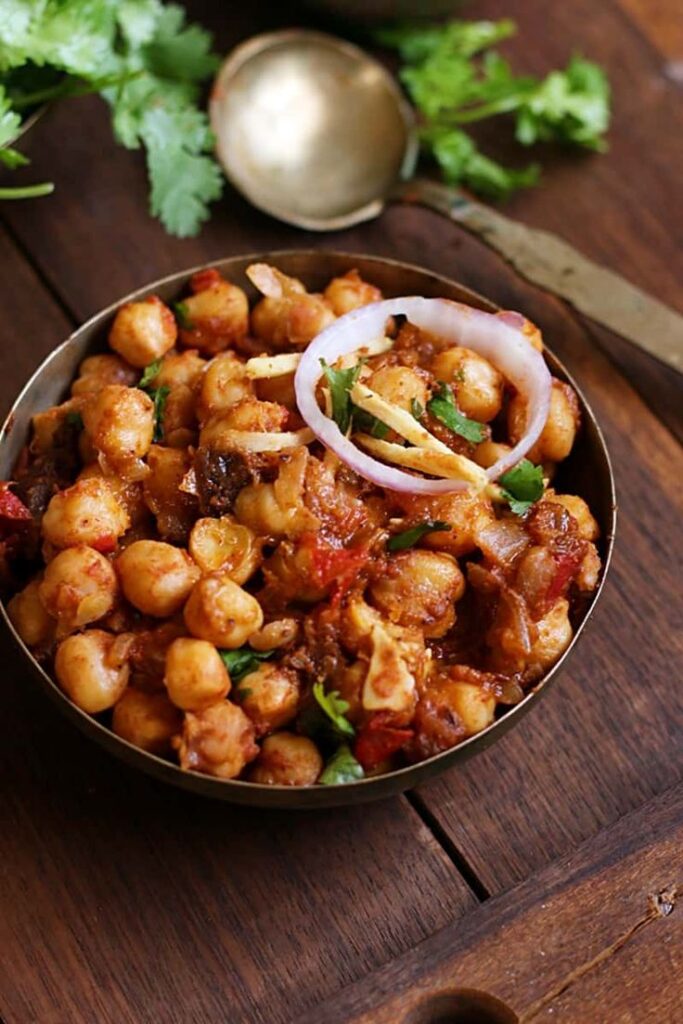 Street vendor serving hot Chole Bhature to customer at zaikastreet