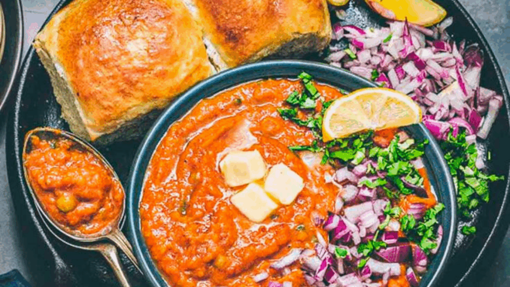 delicious mumbai style pav bhaji served with buttered pav, onion, and lemon wedge at zaikastreet